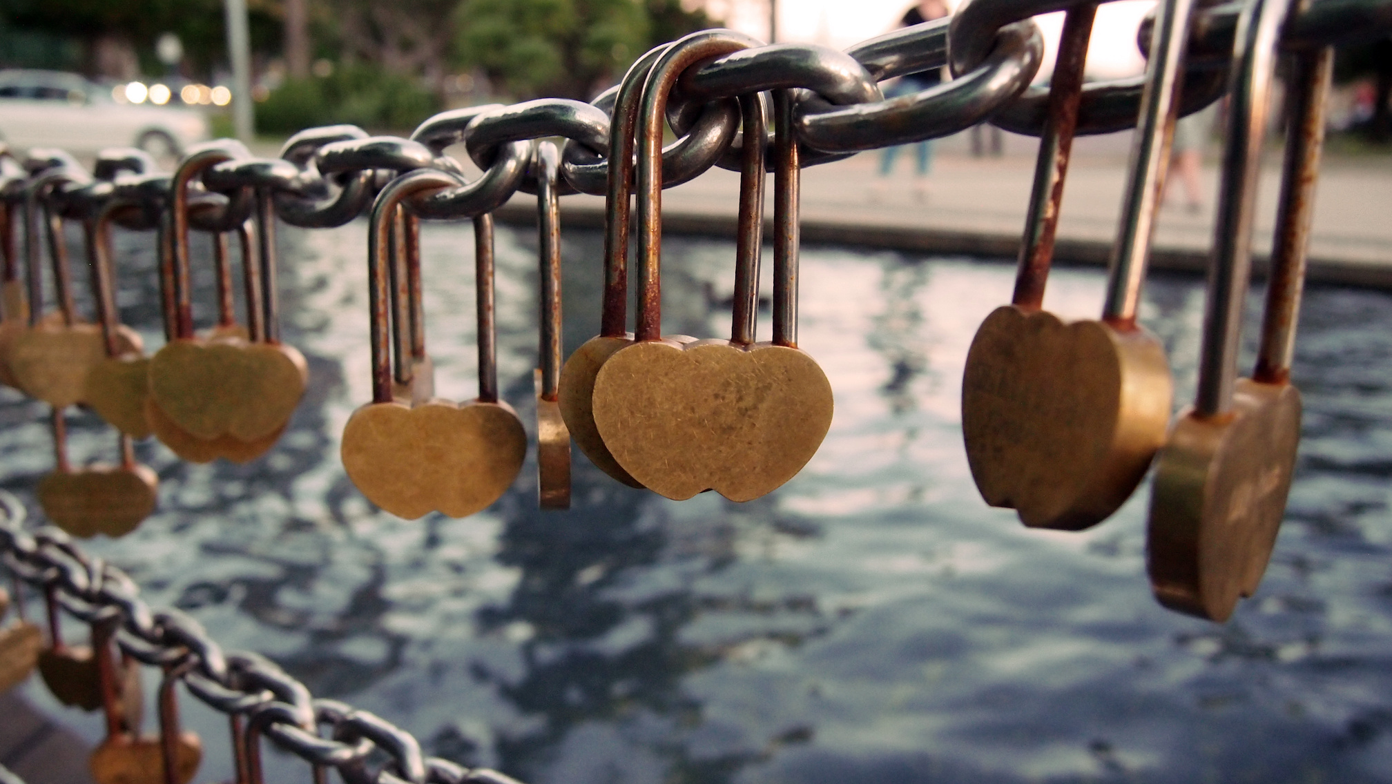 Heart shaped lovelocks locked to a bridge